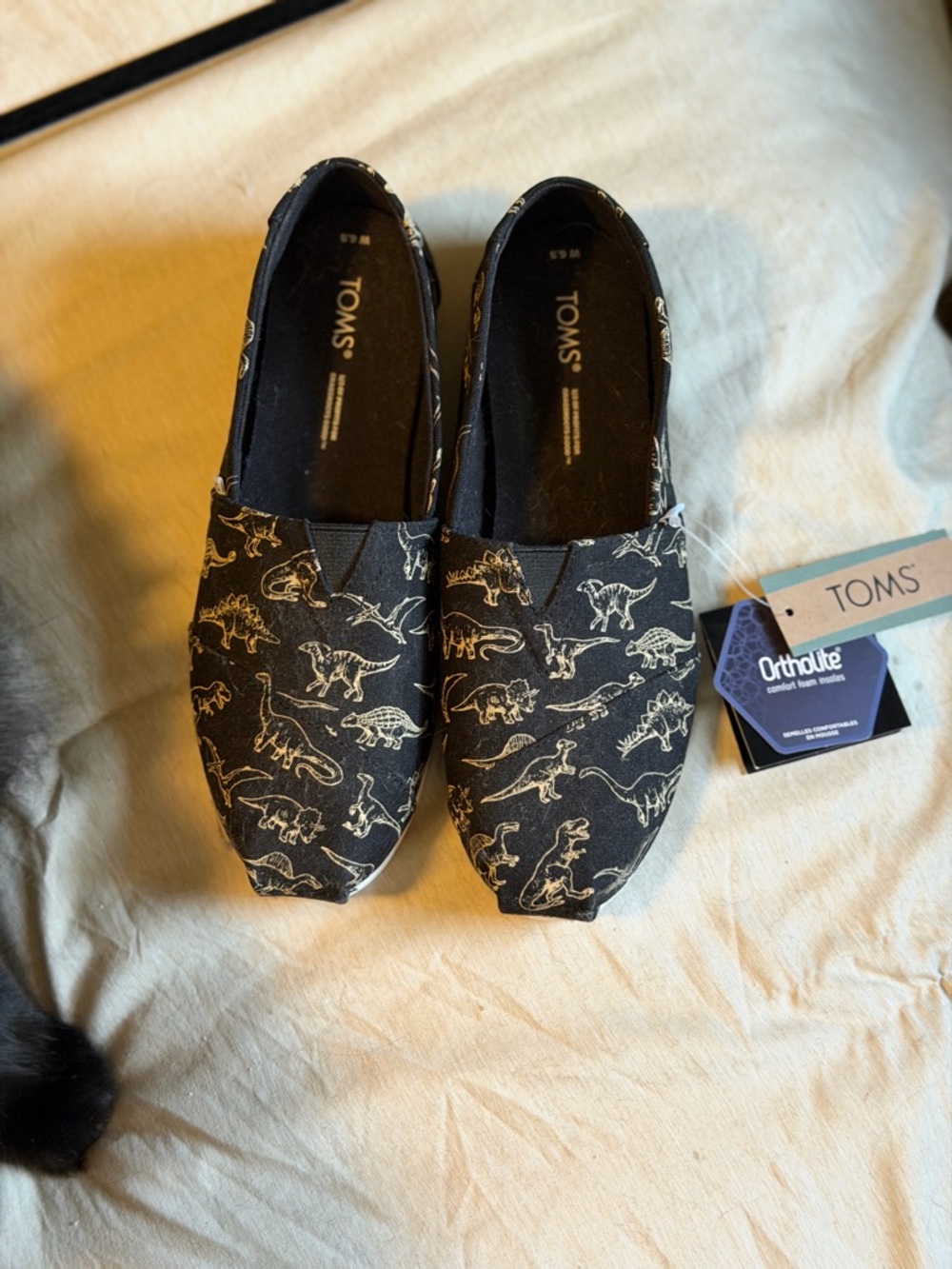 Toms Black Canvas Slip-On Flats with Beige Dinosaur Print